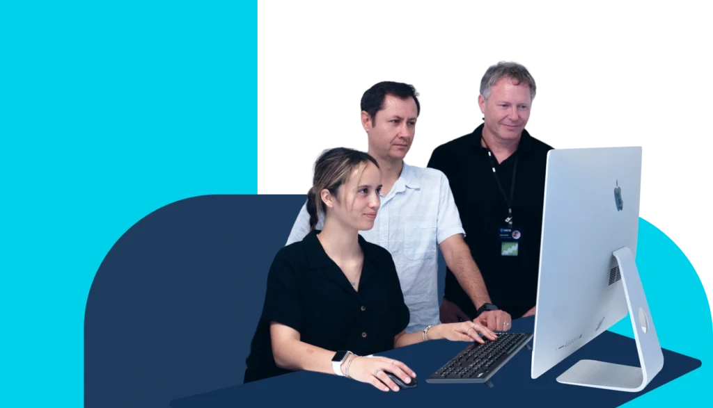 NZCS team helping a client at a desktop computer
